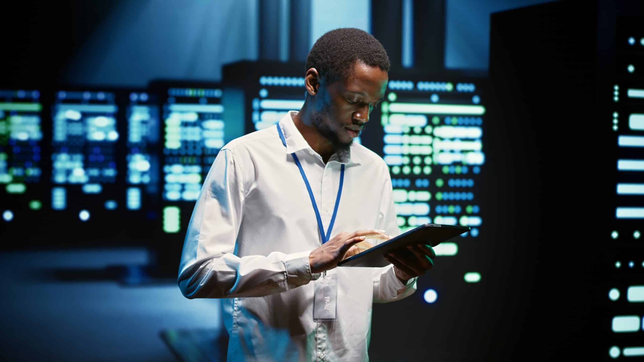 Technician walking through server rigs