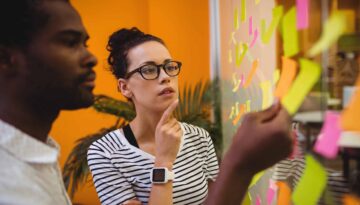 Business executives reading sticky notes