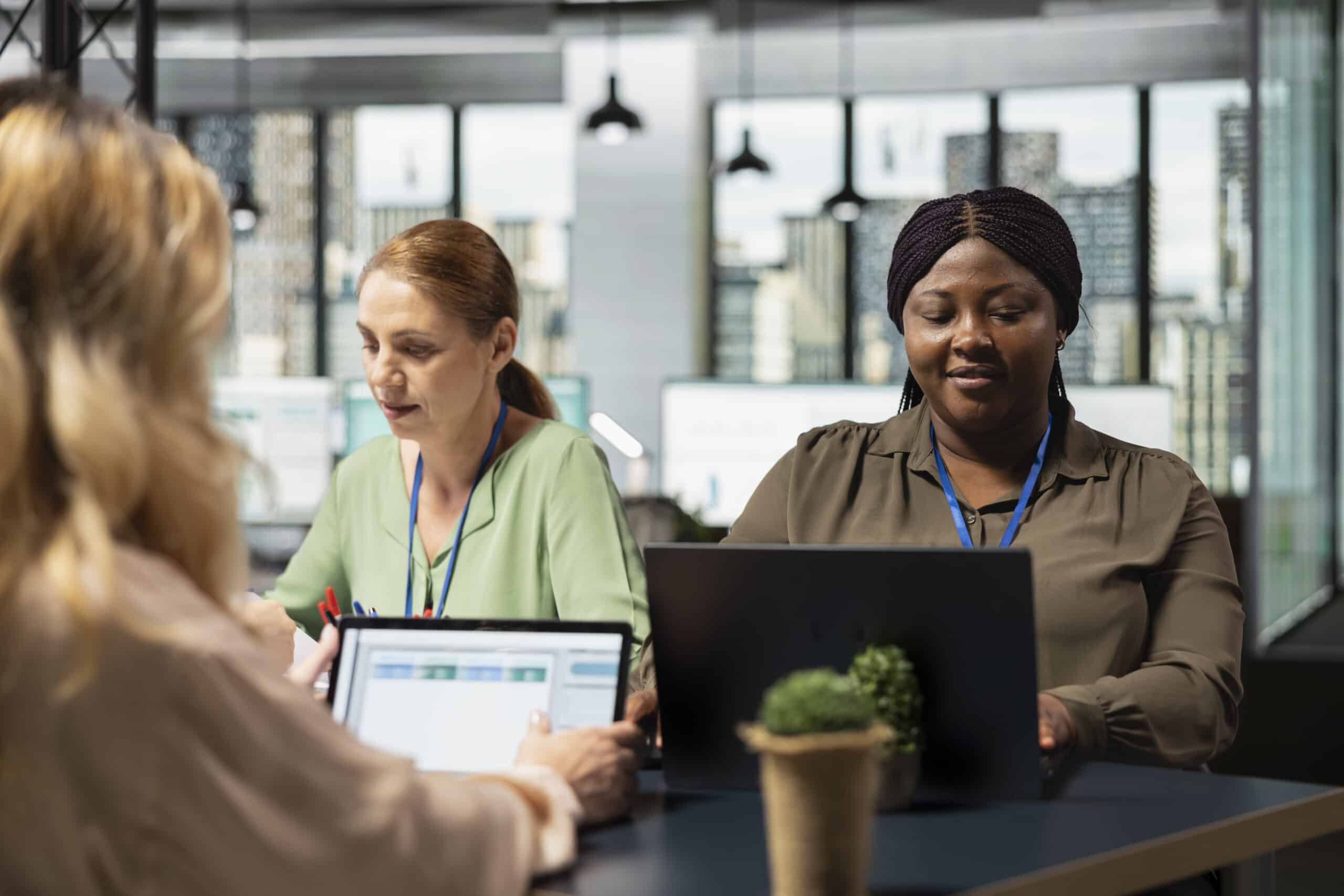 Diverse office colleagues reviewing business insights on laptop