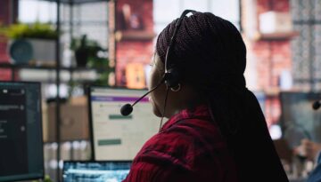 Call center worker in office using AI chatbot to reply to customers